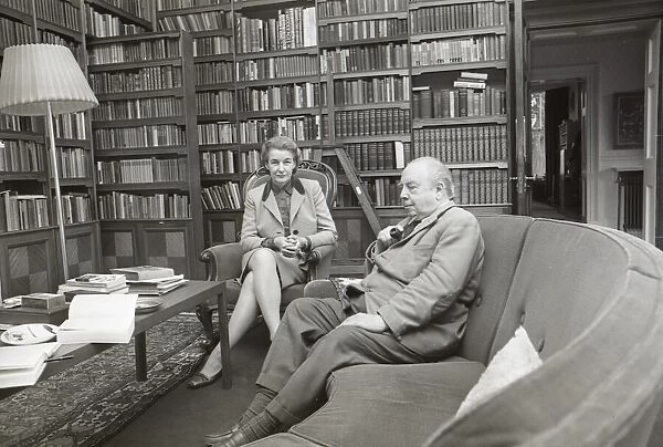 Novelist J. B. Priestley in the library of his home with his wife, Jacquetta Hawkes