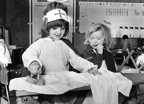 Even a nurse has to get her ironing done as Michelle Tiplady shows with help from Jane
