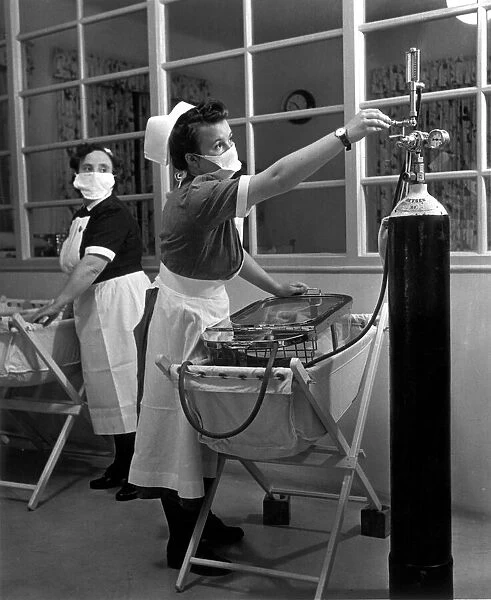 A nurse in the maternity unit of a hospital keeps an eye on the pressure from the oxygen