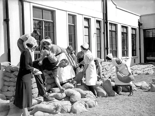 Nurses filling sandbags, September 1939. Women fulfilling mens work duties during