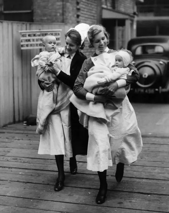 Framed Print : Nurses help evacuate two babies from Great Ormond Street Hospital Circa 1940