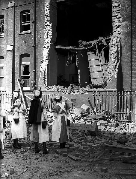 Nurses observe damage done to building by bomb