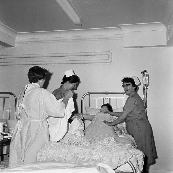 Nurses receiving instruction from Miss V Thomas (in surgical gown) on patient care