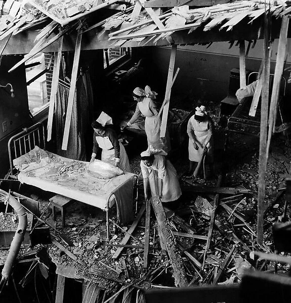 Nurses search the remains of a London hospital 1942 after a night air raid during