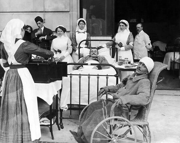 Nurses at an un-named hospital in France play a gramaphone to a few of the soldiers