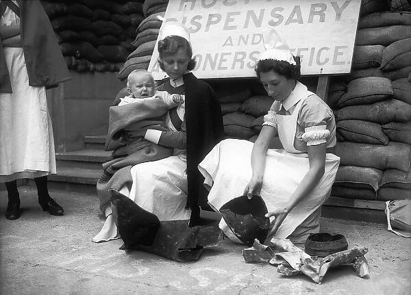 Nurses during WW2, with fragments of a bomb that probably fell in to the grounds of