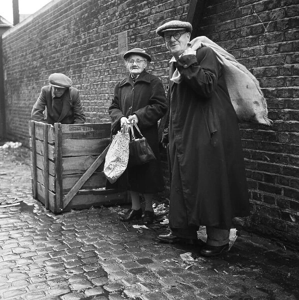 OAPs collecting firewood outside a furniture factory in Denmark Hill, London