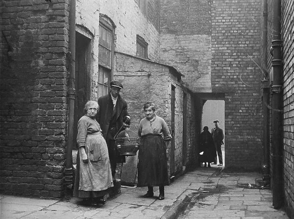 The occupiers of No 3 Court, Clayton Street, Liverpool, with their canary. 2nd March 1933