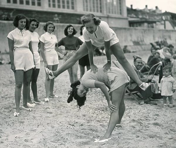 Ocean chorus girls playing leap frog on a beach at Clacton on Sea Playing