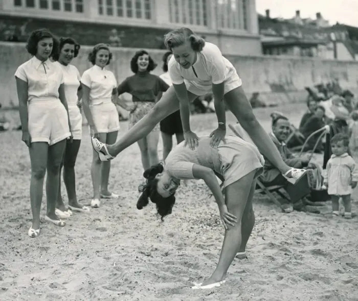 Framed Print : Ocean chorus girls playing leap frog on a beach at Clacton on Sea Playing Framed Print : Ocean chorus girls playing leap frog on a beach at Clacton on Sea Playing