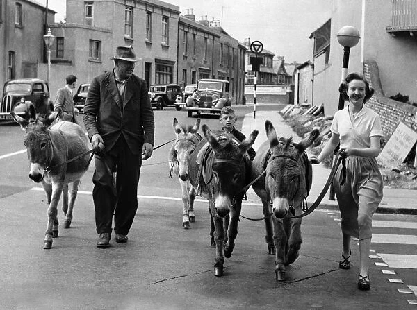 Off to the beach: Mrs. Walsh with Mr. Smith, the donkey man. August 1954 P011888