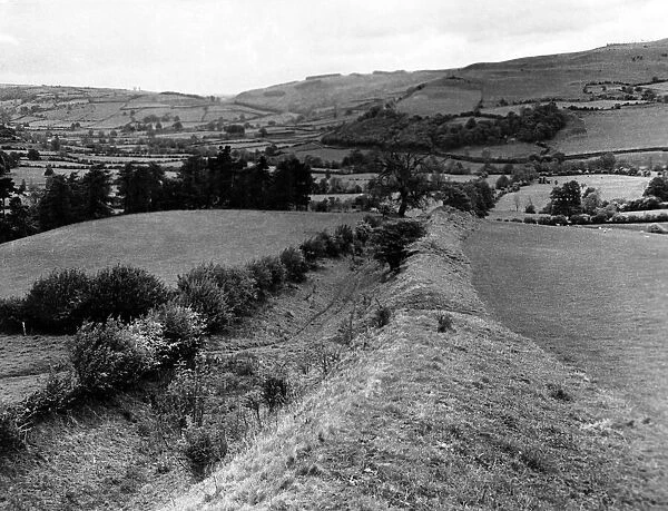 Offas Dyke is a large linear earthwork that roughly follows the current border