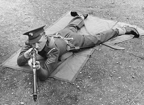 An officer from the Grenadier Guards in a laying combat position