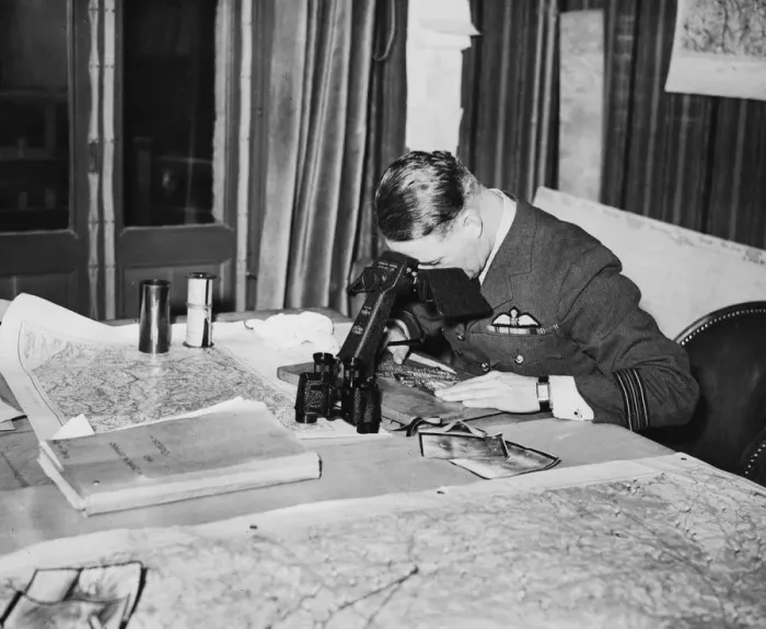 Framed Print : An officer studies reconnaissance pictures taken over Germany at a Wing Headquarters of