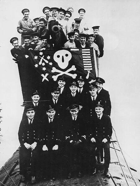 Some of the officers and crew of HMS Proteus seen here on deck with their jolly roger