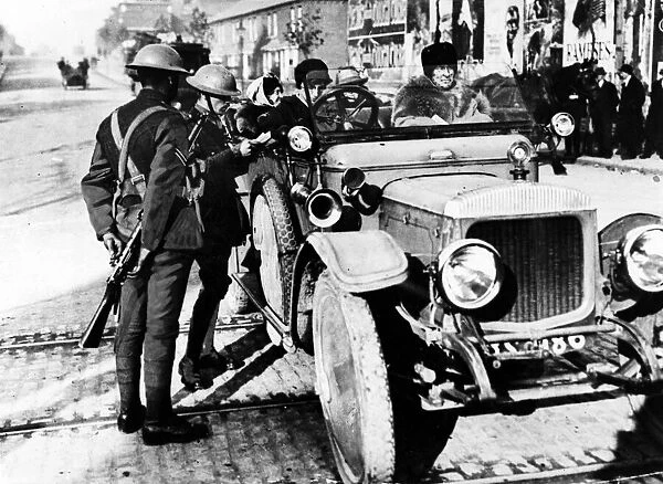 Officers examining the licence of a lady motorist in Dublin. October 1920