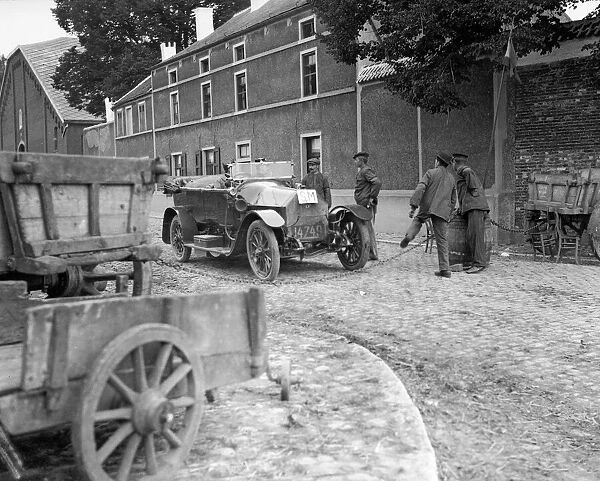 Officers showing their passes to Belgian peasants manning a road block on the road