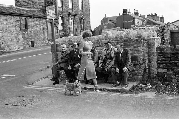 Old boys watch the girls go by from the bench at the junction of Keighly Road, Silsden