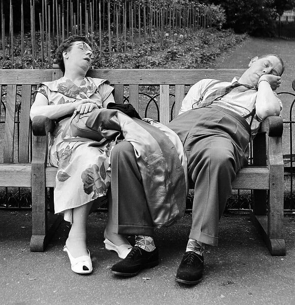 Old couple dozing in the sun at Serpentine Lido, Hyde Park. 16th June 1958