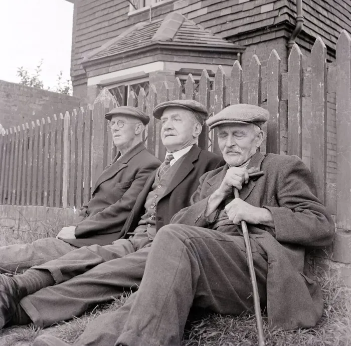 Framed Print : Three old gentlemen rest up against a wooden picket fence and watch the world go by Framed Print : Three old gentlemen rest up against a wooden picket fence and watch the world go by