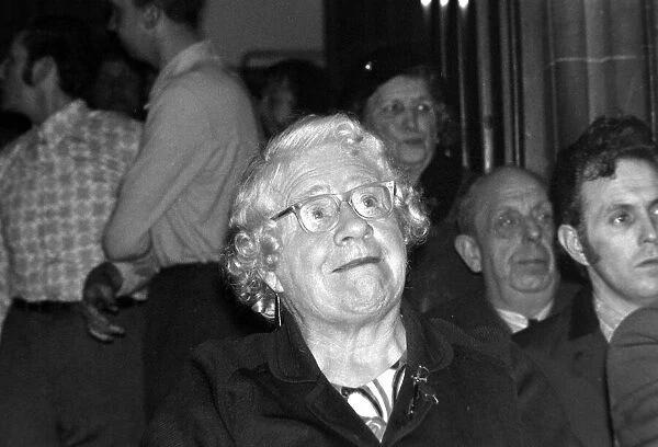 A old lady in the audience cheers on the wrestlers at the Chester Town hall