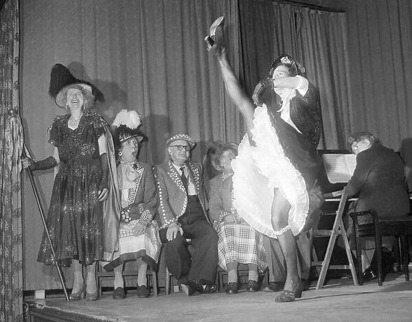 Old lady performs the can-can during a concert by pearly kings and queens