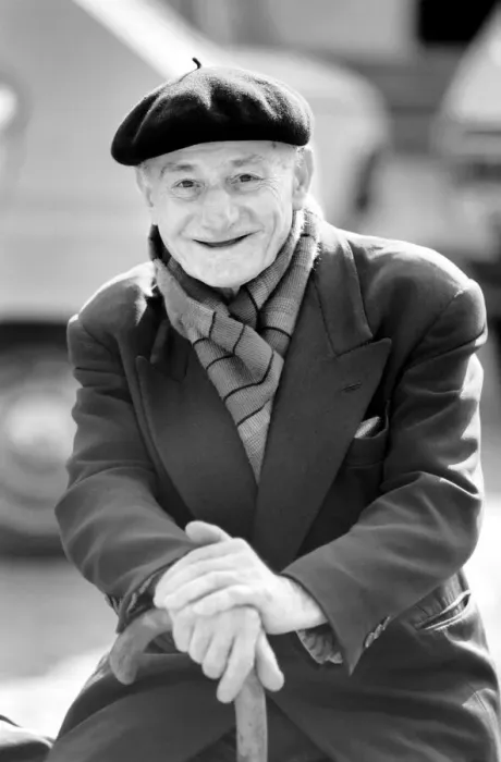 Framed Print : An old man of Paris wearing beret, scarf and coat on a coald day in France April