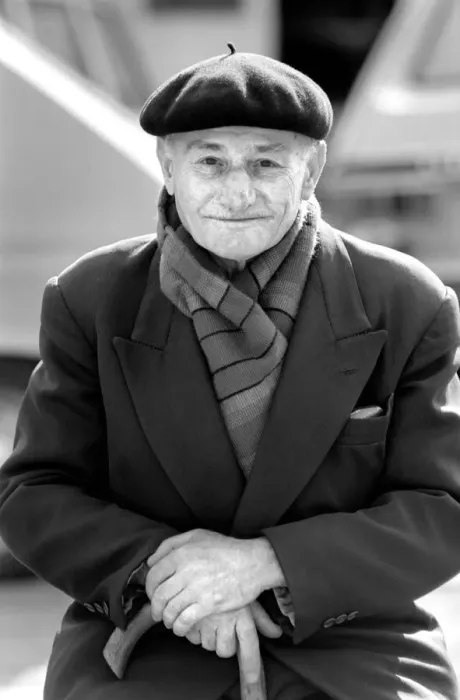 Framed Print : An old man of Paris wearing beret, scarf and coat on a coald day in France April
