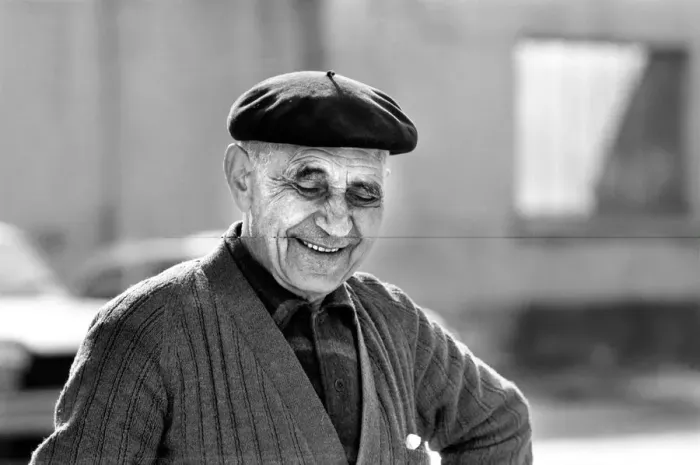 Framed Print : An old man of Paris wearing beret, scarf and coat on a cold day in France April