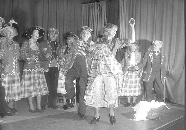 Old people dressed as Pearly Kings and Queens dancing on stage during a concert
