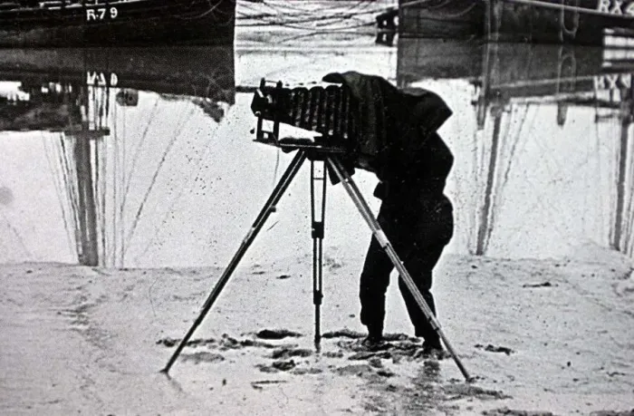 Framed Print : OLD PHOTOGRAPH OF A PHOTOGRAPHER ON THE BEACH MARCH 2001 USING A PLATE CAMERA ON