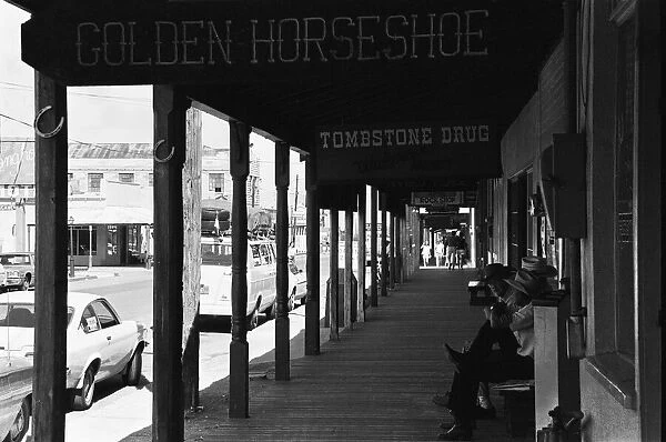 Three old timers sit outside the Tombstone Drug store close to the site of the famous