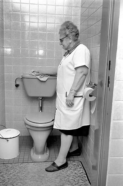 An old woman cleaning the toilet. November 1969 Z10818-001