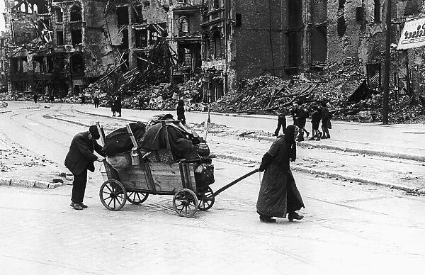 An old woman and her husband July 1945 trundle through the Leipzig Strasse of
