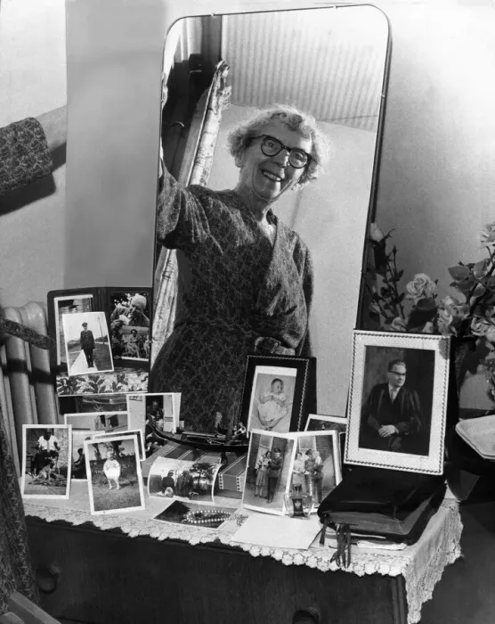 Framed Print : Old woman smiling at bedroom mirror in her newly-built Home. 9th october 1963