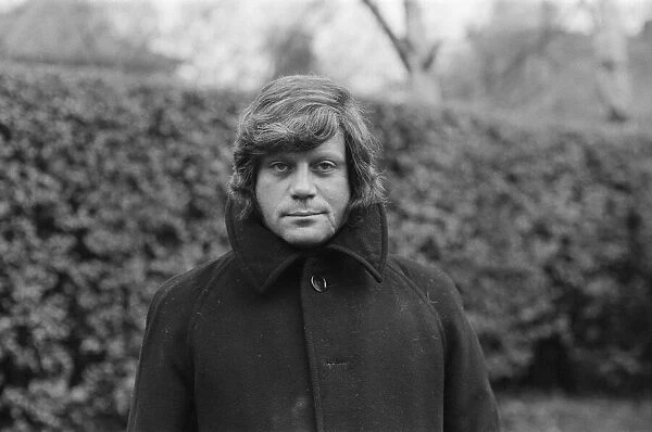 Oliver Reed wearing his wig at his home in Wimbledon, South West, London