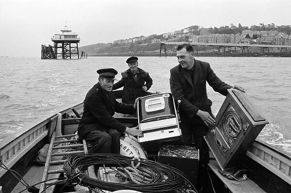 Three one-armed bandits which have been marooned for a weekend at Clevedon, Somerset