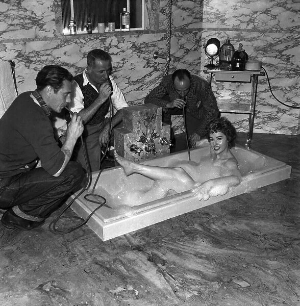 The oriininal bubble bath Woman taking a bath as three men blow through pipes to
