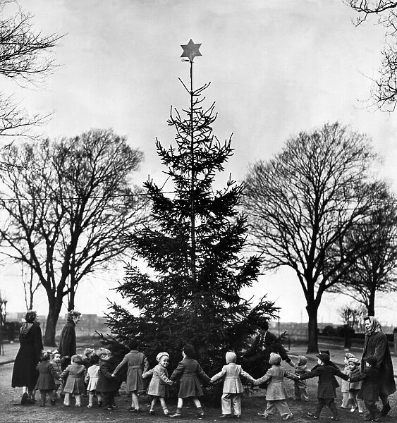 Orphans fropm Liverpool Cottage Homes, Fazakerley, dance round a Christmas tree