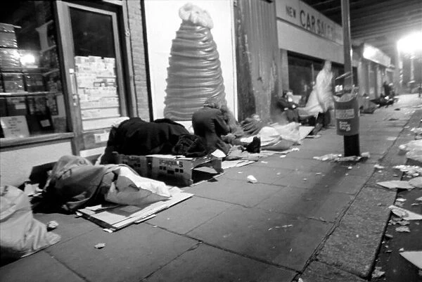 Down and outs sleep rough under the arch of the back entrance of Charing Cross Station
