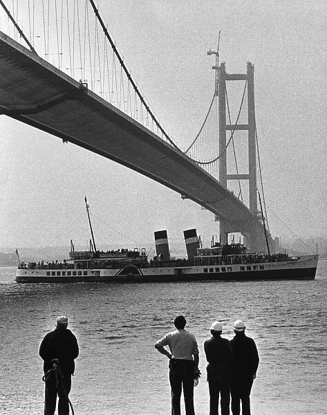 The paddle steamer Waverley passes under the Humber Bridge as it nears completion