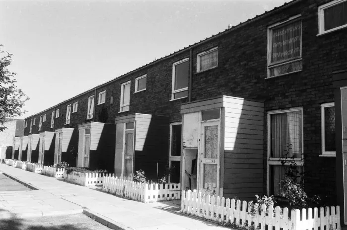 Framed Print : Painted council houses and the unpainted ones - part of a battle of home buying at a Framed Print : Painted council houses and the unpainted ones - part of a battle of home buying at a