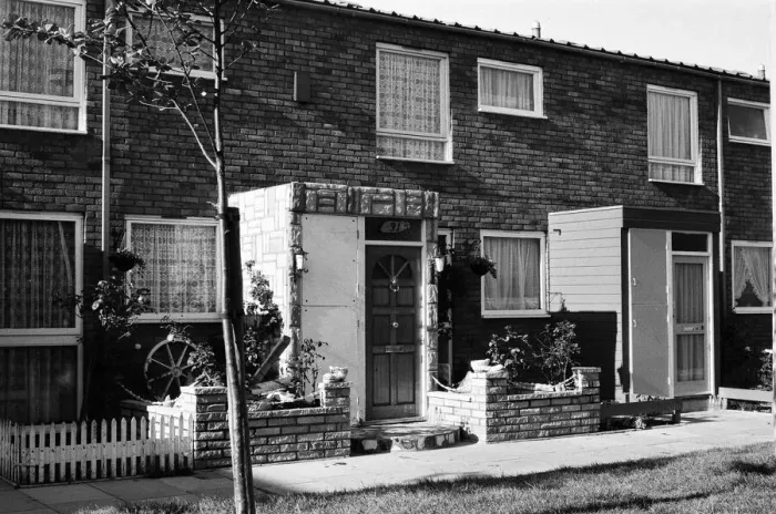 Framed Print : Painted council houses and the unpainted ones - part of a battle of home buying at a