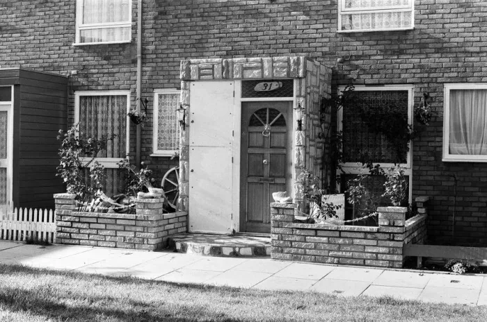 Framed Print : Painted council houses and the unpainted ones - part of a battle of home buying at a Framed Print : Painted council houses and the unpainted ones - part of a battle of home buying at a