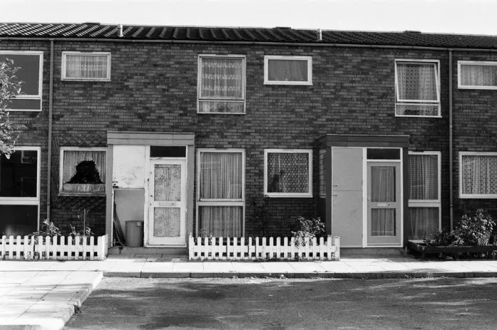 Framed Print : Painted council houses and the unpainted ones - part of a battle of home buying at a Framed Print : Painted council houses and the unpainted ones - part of a battle of home buying at a