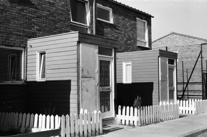 Framed Print : Painted council houses and the unpainted ones - part of a battle of home buying at a