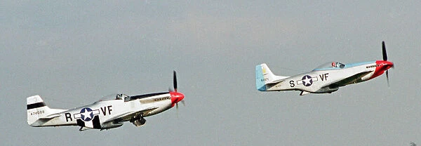 A pair of P51 North American Mustangs flying in formation at the Wroughton Airshow in