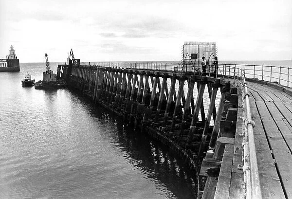 A pair of young anglers prepare to enjoy a quite afternoon fishing on Blyth Pier