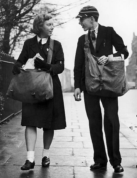 A paperboy and papergirl, dressed in their school uniforms