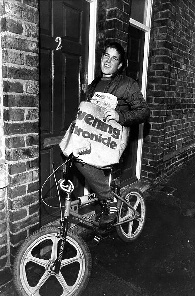 Paperboy Stephen bikes it round his round. 15th October 1983